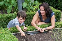 Dawn Isaac gardening with her 8 year old son, Oscar.