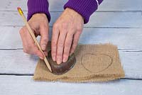 Using a pencil mark the outline of the heart shape onto the hessian
