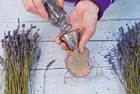 Use a funnel to assist with filling the hessian heart with the dried Lavender flowers
