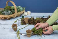 Pad out the wreath frame with moss, making sure the green side is facing outwards