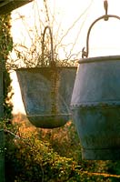 Rustic metal containers. Lesley Rosser's garden. Gloucestershire