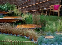 Canoe decking terraces surrounded by grasses and wattle fence surround, hcfs 2002, the river cam, Design: Jo Montague Fuller