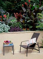 Outdoor furniture on patio with tropical borders
