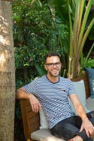 Landscape designer Adam Robinson seen in a garden he designed in Fairlight, Sydney