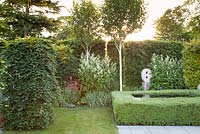 Clipped box hedge around Infinity pool with contemporary statue 'Untitled' by artist Will Spankie, white Astilbe, Red Valerian, Silver Birch and Beech hedging