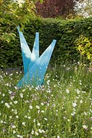 Contemporary sculpture by local artist Martin Cundall amongst wildflower planting of Ragged Robin Yellow Rattle, Lesser Knapweed, Red Campion and ox eye daisies

