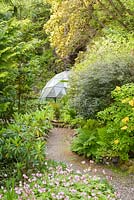 Attadale, Strathcarron, Scotland. Hardy geraniums, Azalea luteum and ferns by geodesic dome fernery