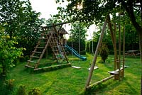 Childrens play area in a circular garden with hornbeam hedge boundaries 