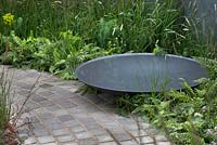 Crescent shaped cobbled path with steel water bowl in'A Quiet Corner' at RHS Tatton Flower Show 2015