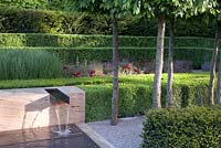 Hedging around modern water feature. The Laurent-Perrier Garden Design: Luciano Giubbilei Gold Medal winner, RHS Chelsea Flower Show 2009. Contemporary water feature, box hedging, formal hornbeam