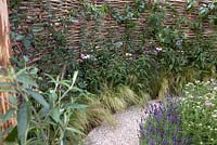 Shell pathway and woven fencing with lavender, grasses, rudbeckia and climbers.'It's Only Natural', Designer: Marianne Krogh Ali, Hampton Court 2010