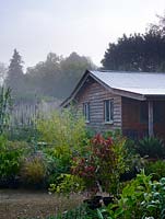 The sales hut backs on to the garden with plants such as acanthus, echinops and arundo donax