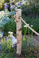 Silver Birch tree log used as fence post - Hampton Court Flower Show 2014, the Flintknappers Garden, designer: Luke Heydon. 