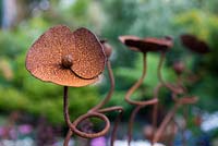 Rusted steel sculpture - closeup detail of a poppy. 