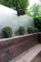Rail sleeper raised bed and seating with aluminium sheet fencing and outdoor heater