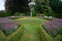 Box edged beds full of lavender surround the mount at the centre of the Sundial Garden at Cranborne Manor Garden, Dorset in summer