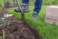 Use the spade to dig 7 to 8 inches below ground level to create the foundations