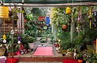 Inner city garden with begonias, ferns and palms features colourful eclectic retro pieces sourced from local markets. 