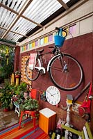 Inner city garden with cyclamens, ferns and succulents features colourful eclectic retro pieces sourced from local markets. 