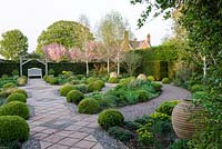 Mitton Manor Garden in spring, Staffordshire. The formal box topiary garden