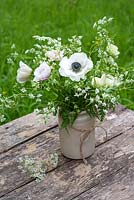 Anemones and cow parsley in pottery vase