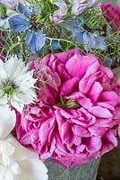Roses and nigella damascena in floral arrangement