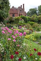 Chenies Manor summer garden. Showing Sunken Garden and House with Dahlia 'Stolze von Berlin' and Dahlia 'Western Pirate' -  Chenies Manor Gardens, Bucks, UK