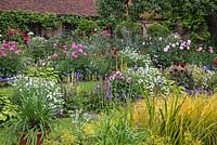 Chenies Manor 'Sunken Garden' - Showing double borders with Dahlia, Sisyrinchium, Petunia, Hosta, Greanium, Argyranthemum, Eryngium, Tanacetum parthenium, Agapanthus, Rosa - Chenies Manor Gardens, Bucks, UK