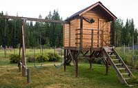 Play area - wooden playhouse, swings