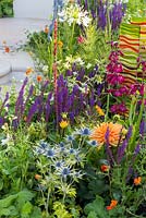 New Horizons, Colourful planting including drought resistant choices such as Eryngium x zabelii 'Neptune's Gold and Geum 'Fire Opal', as well as Dahlia 'Ludwig Helfert', Salvia nemerosa 'Ostfriesland', Penstemon 'Raven',  and Agapanthus africanus 'Alba'. 