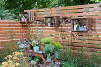 Cut flower garden with crates used for shelving on a slatted fence - Katie's Lymphoedema Fund: Katie's Garden, RHS Hampton Court Palace Flower Show 2016