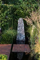 Reflecting pool with brick stepping stone and flint sculpture - Streetscape's Summer in Sussex, RHS Hampton Court Palace Flower Show 2016