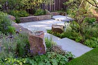 The M and G Garden. Large stone seats and bird bath rocks in sunken terrace. RHS Chelsea Flower Show, 2016 Designer: Cleve West MSGD, Sponsor: M and G 