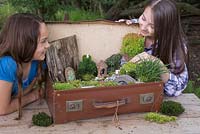 Two girls happy with their completed miniature garden project