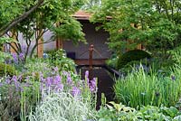 The Morgan Stanley garden for Great Ormond Street Hospital. Shaded woodland garden with water feature and japanese style summer house. RHS Chelsea Flower Show 2016, Designer: Chris Beardshaw, Sponsors: Morgan Stanley