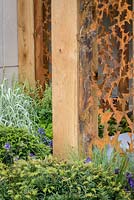 Detail of the oak pavilion with rusty oak-leaf pattern The  Morgan Stanley Garden For Great Ormond Street Hospital. The RHS Chelsea Flower Show 2016 