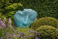 Fallen Deodar' by Jilly Sutton - a sculpture of a face made from Himalayan Cedar in The  Morgan Stanley Garden For Great Ormond Street Hospital. The RHS Chelsea Flower Show 2016 - Designer: Chris Beardshaw - Sponsor: Morgan Stanley - GOLD