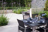 View from dining area towards patio with sunken planting featuring Verbena bonariensis