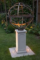 A personalised sundial by David Harber with uplight lighting.