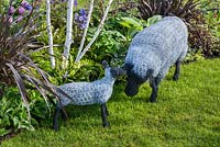 Wire sheep sculptures in front of Betula utilis var Jacquemontii and Phormium 'Platt's Black' - Hidden Gems of Worcestershire, RHS Malvern Spring Festival 2016 . Design: Nikki Hollier. Silver, Best Festival Garden