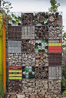 Gabions filled with natural and recycled objects as decorative feature and wildlife habitat. Garden: 'Nature Squared' at RHS Tatton Park Flower Show 2012