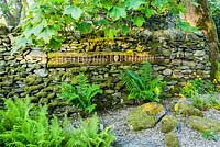 'Going by Sleeper'. Wood and stone artwork inserted into drystone wall.