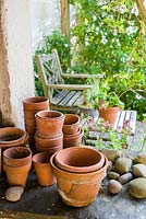 Collection of old terracotta pots and pebbles.