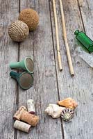 A variety of materials that can be used as cane toppers. Tennis balls, wine corks, seashells, glass vases and bottles