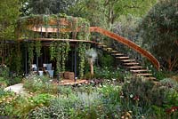 Belvedere in the Winton Beauty of Mathematics Garden, Chelsea Flower Show 2016. Mathematical symbols cut into band of copper used as bannister for staircase. Pinus sylvestris 'Glauca' - blue Scot's pine, Yucca rostrata - Beaked Yucca