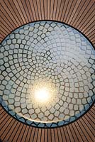 Detail of illuminated glass panels emulating the mathematically perfect Fibonacci spiral inset into the wooden floor of the belvedere in the Winton Beauty of Mathematics, Chelsea Flower Show 2016.