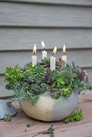 A Pumpkin candle holder planted with Succulents