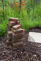 Materials required for constructing a barbecue are bricks, a paving slab and two metal grills