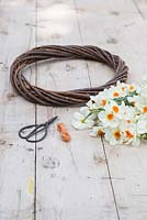 Plain wreath, scissors, string and Narcissi 'Geranium'