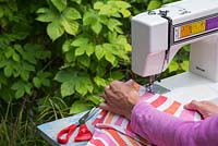 Use a sewing machine to create a deck chair cover from the fabric